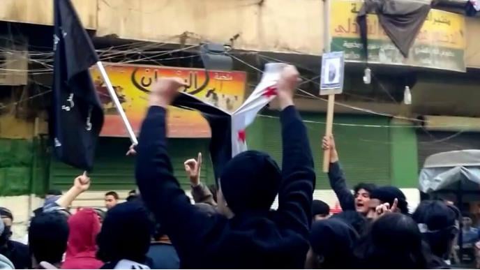 Between Images of Bin Laden, and the Revolution's Flag in Aleppo!