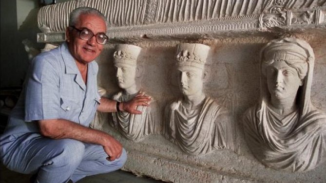 Why did the executed antiquities scholar choose to stay in Palmyra when ISIS controlled the city?