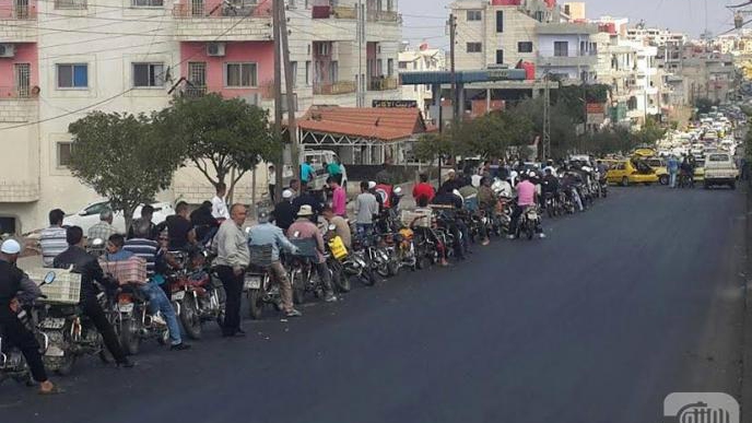 SUWAYDA DRIVERS: PLAYING CARDS WHILE WAITING FOR GASOLINE
